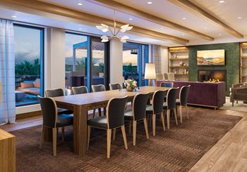 a dining room with a long wooden table and chairs at Lilia, Minnesota, 55118